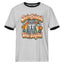A light heather gray ringer t-shirt with black trim on the collar and sleeve cuffs, featuring a retro-style graphic of a grumpy gray cat in a tie holding a mug, surrounded by a rainbow and flowers, with the text 'Overcaffeinated Under Stimulated'.