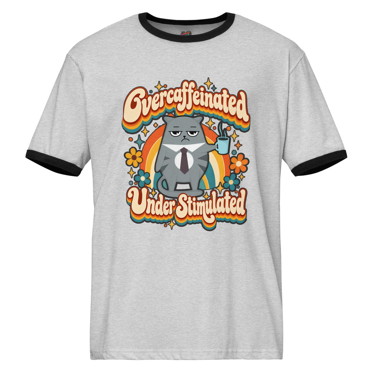 A light heather gray ringer t-shirt with black trim on the collar and sleeve cuffs, featuring a retro-style graphic of a grumpy gray cat in a tie holding a mug, surrounded by a rainbow and flowers, with the text 'Overcaffeinated Under Stimulated'.
