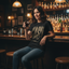 A woman sitting at a bar counter wearing a black graphic t-shirt with a distressed beige 'CASH' print and blue jeans, holding a glass of dark beer. The background shows a warmly lit bar interior with shelves of liquor bottles and hanging lamps.