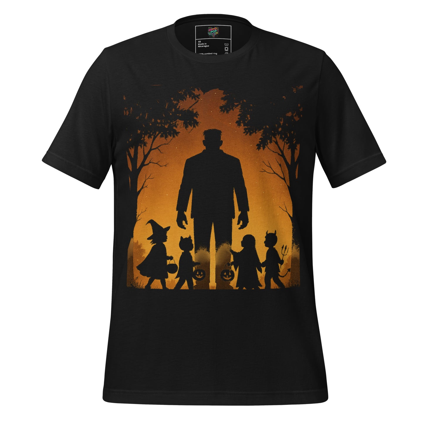 A black short-sleeve crewneck t-shirt featuring a Halloween-themed graphic print on the front. The print shows a large silhouette of a man in a top hat and suit, accompanied by a witch, a cat in a pumpkin suit, and two children, all set against a glowing orange background with silhouetted trees.