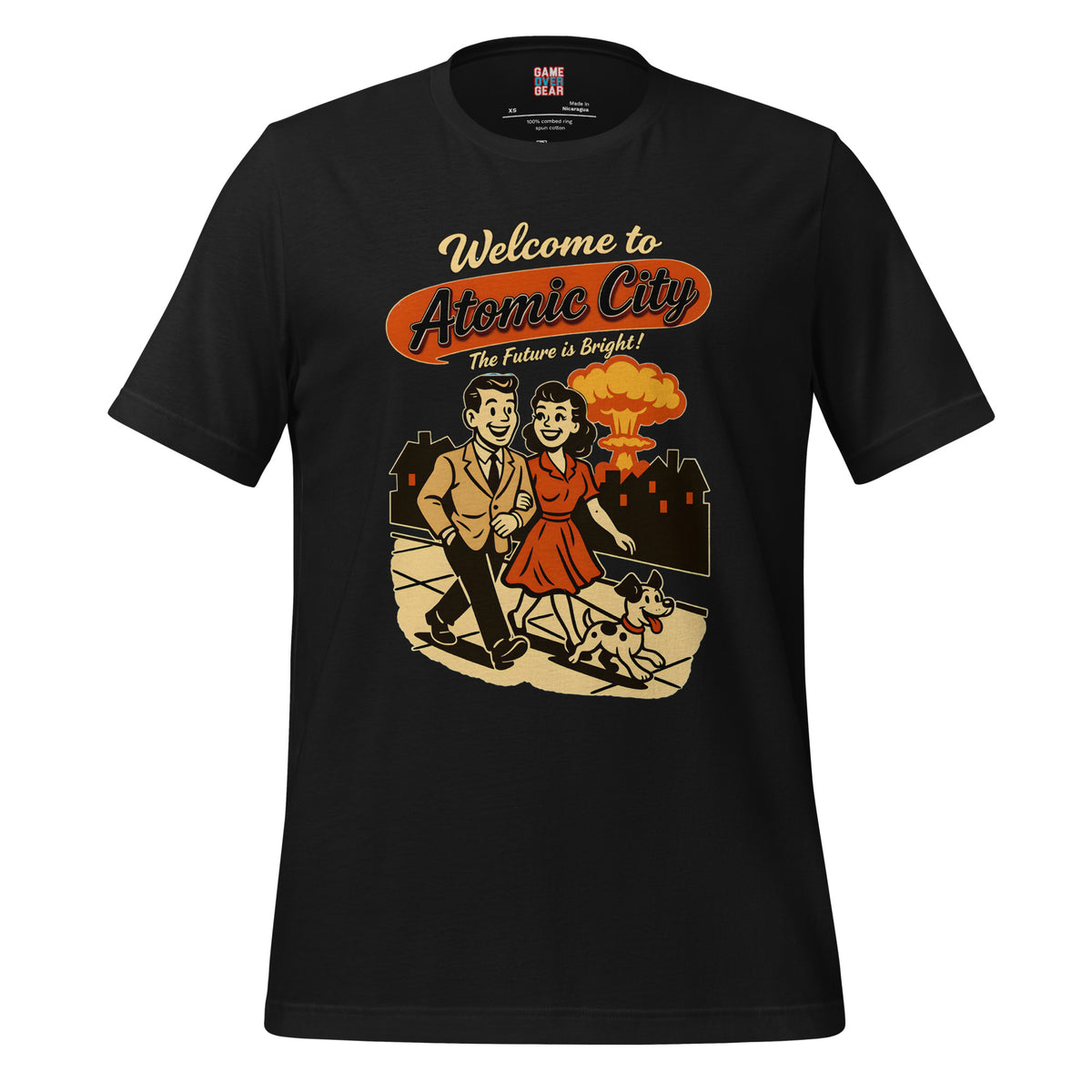 A black short-sleeve crewneck t-shirt with a retro graphic on the front reading 'Welcome to Atomic City The Future is Bright!' above an illustration of a man and woman walking with a dog in front of a nuclear explosion.