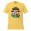 A yellow short-sleeve crewneck t-shirt featuring a colorful retro graphic of three UFOs with beams of light, a red car, and cows on a grassy field.
