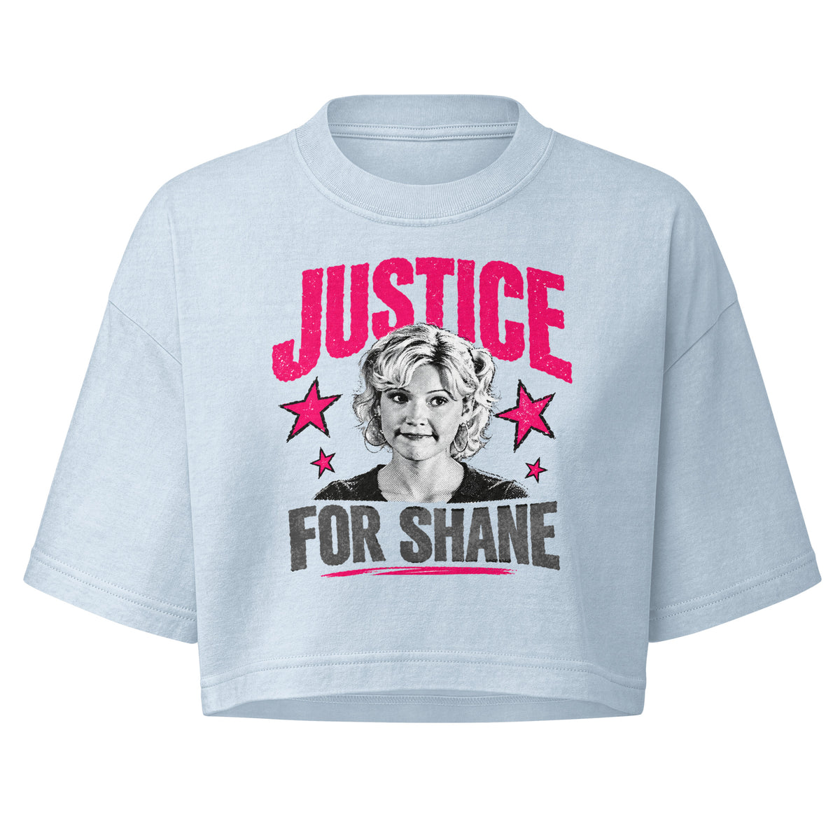 A light blue cropped t-shirt featuring a graphic print with the text 'JUSTICE FOR SHANE' in pink and black, flanking a portrait of a woman and pink stars.
